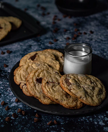 A tempting spread of chocolate brownies and cookies on a white ceramic plate.