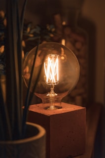 clear glass candle holder with lighted candle