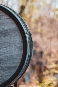 Close-up of a vintage wine barrel with rich wood textures and soft ambient lighting.