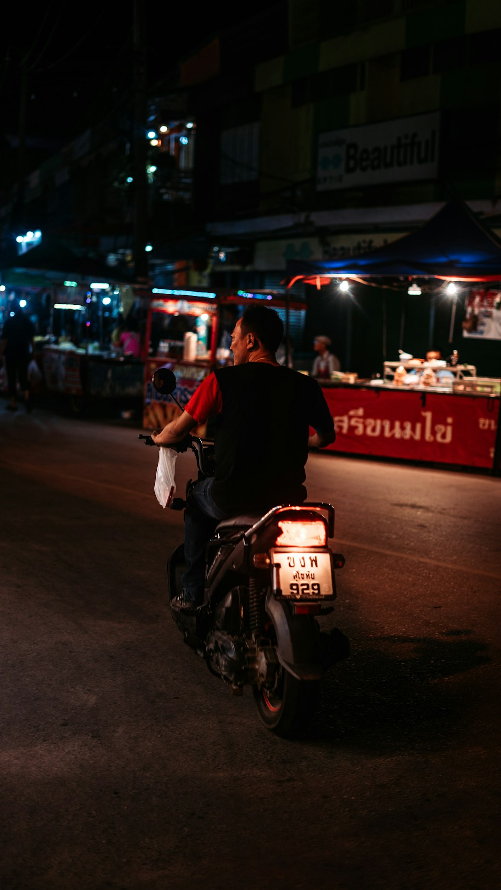 man in black jacket riding motorcycle during night time