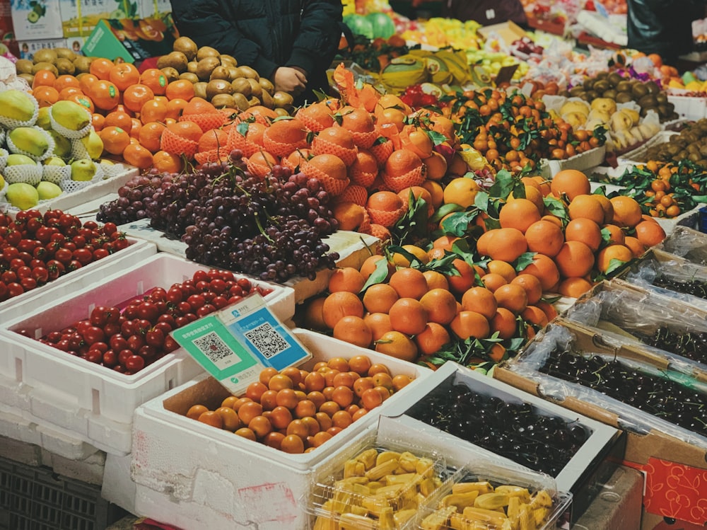 orange fruits on white plastic crate