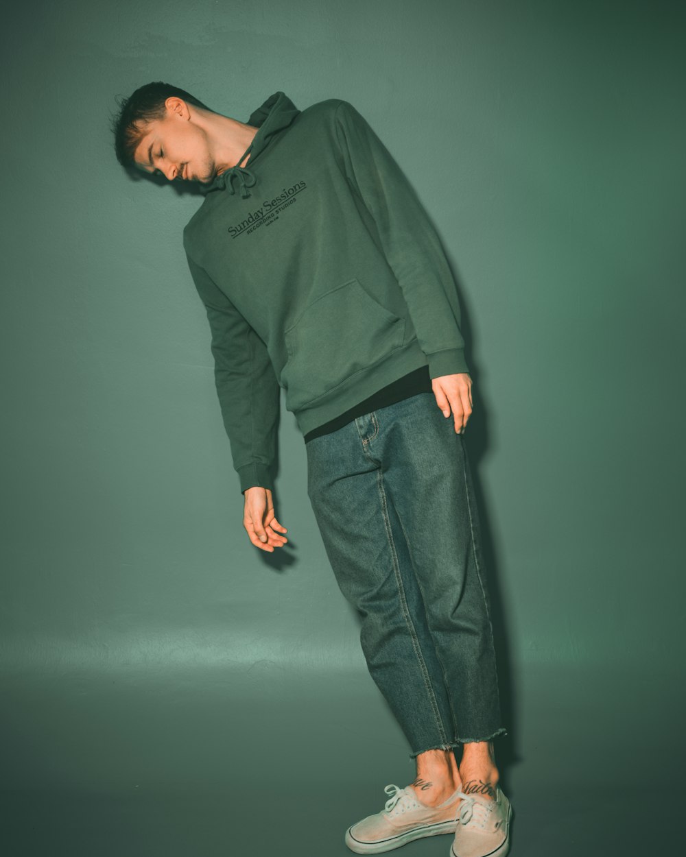 man in green long sleeve shirt and black pants