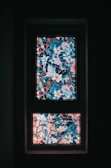 Close-up of a colorful stained glass window with floral patterns.