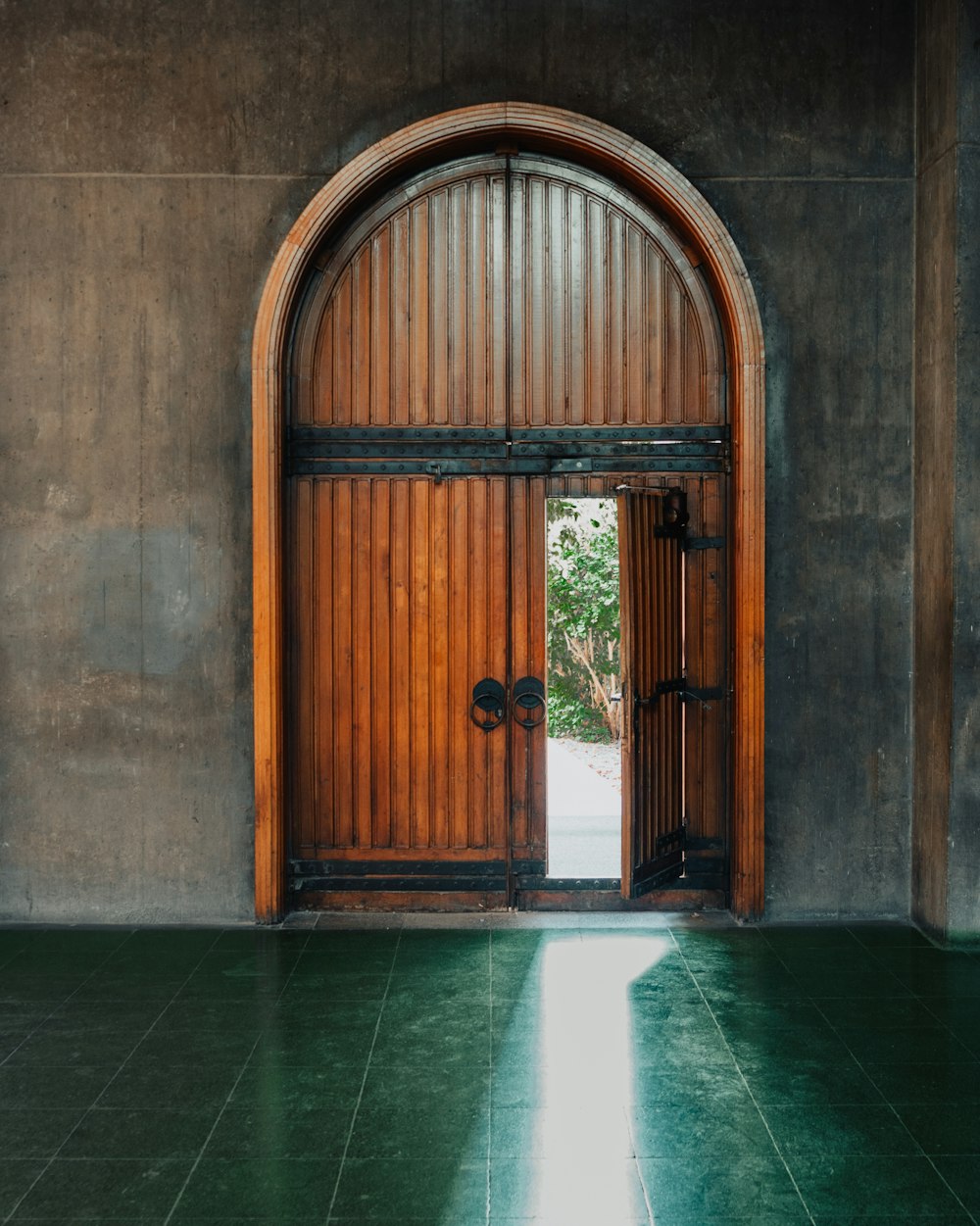 brown wooden door on gray concrete wall