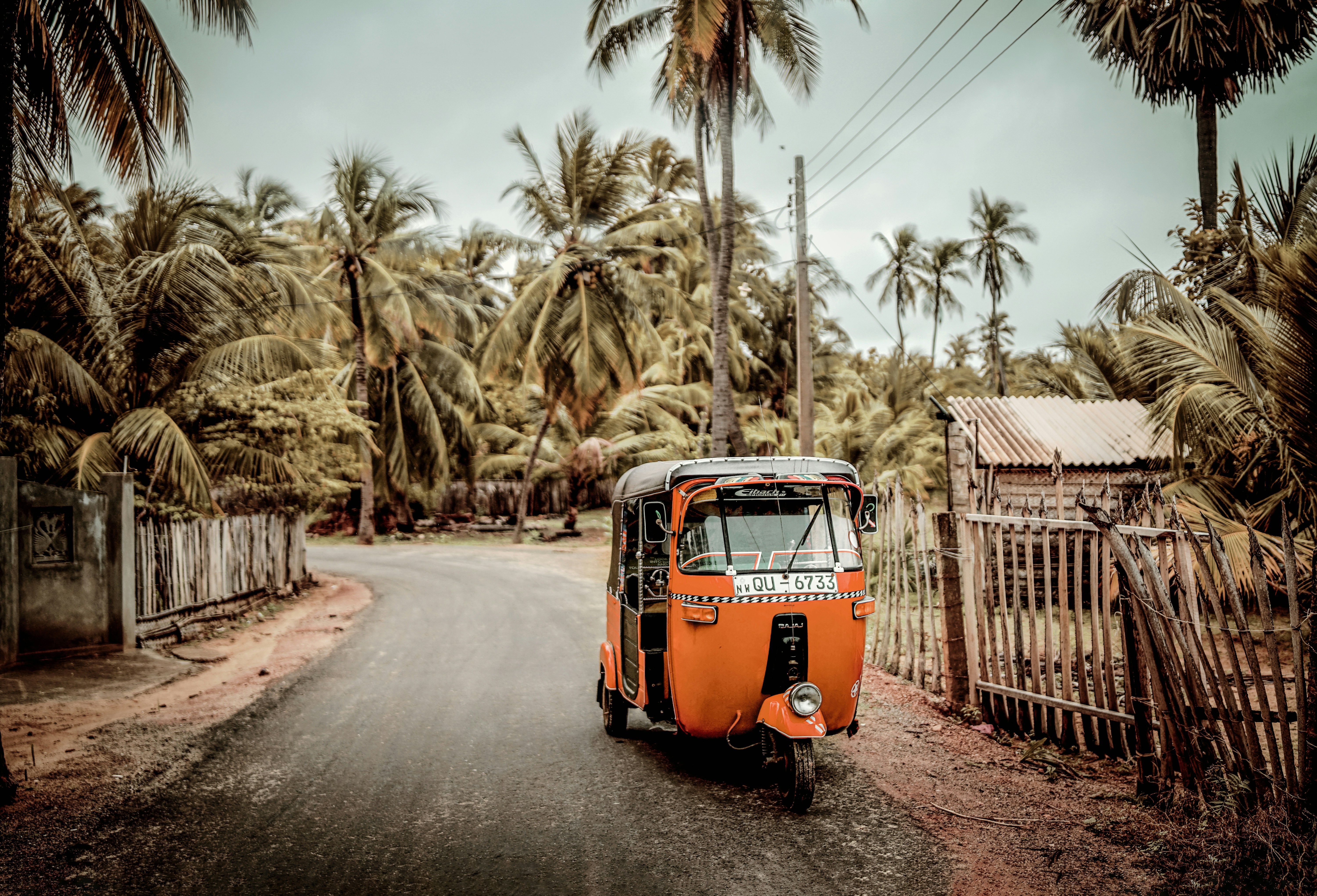 orange volkswagen t-2 van parked on the side of the road