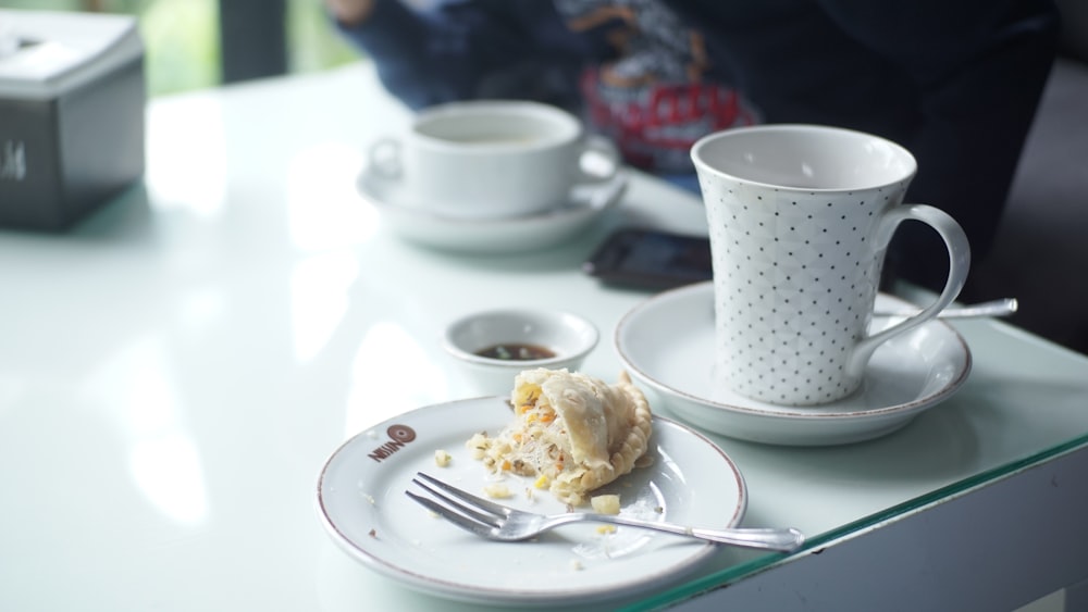 white ceramic mug on white table