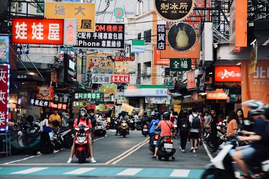 people riding motorcycle on road during daytime in Taichung Taiwan