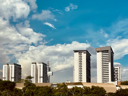 white and blue concrete building under blue sky during daytime in Lower Kent Ridge Road Singapore