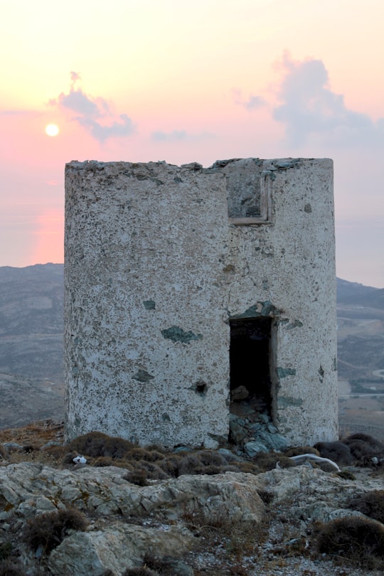 gray concrete building on rocky shore during daytime in Serifos Greece