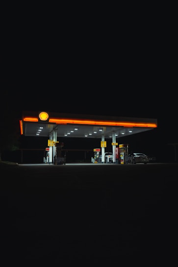 A modern Shell gas station with bright signage and clean pumps.
