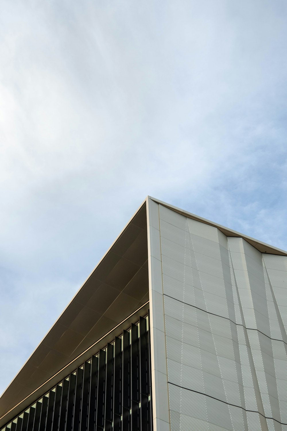 gray concrete building under white clouds during daytime