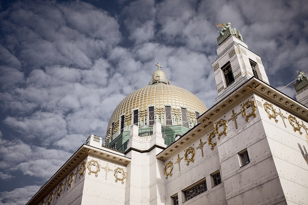 white and green dome building under cloudy sky during daytime