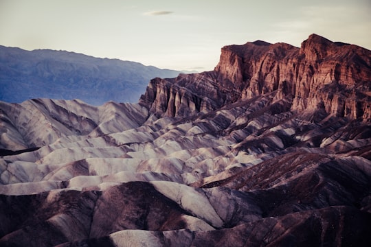 brown rocky mountain under blue sky during daytime in Death Valley National Park United States