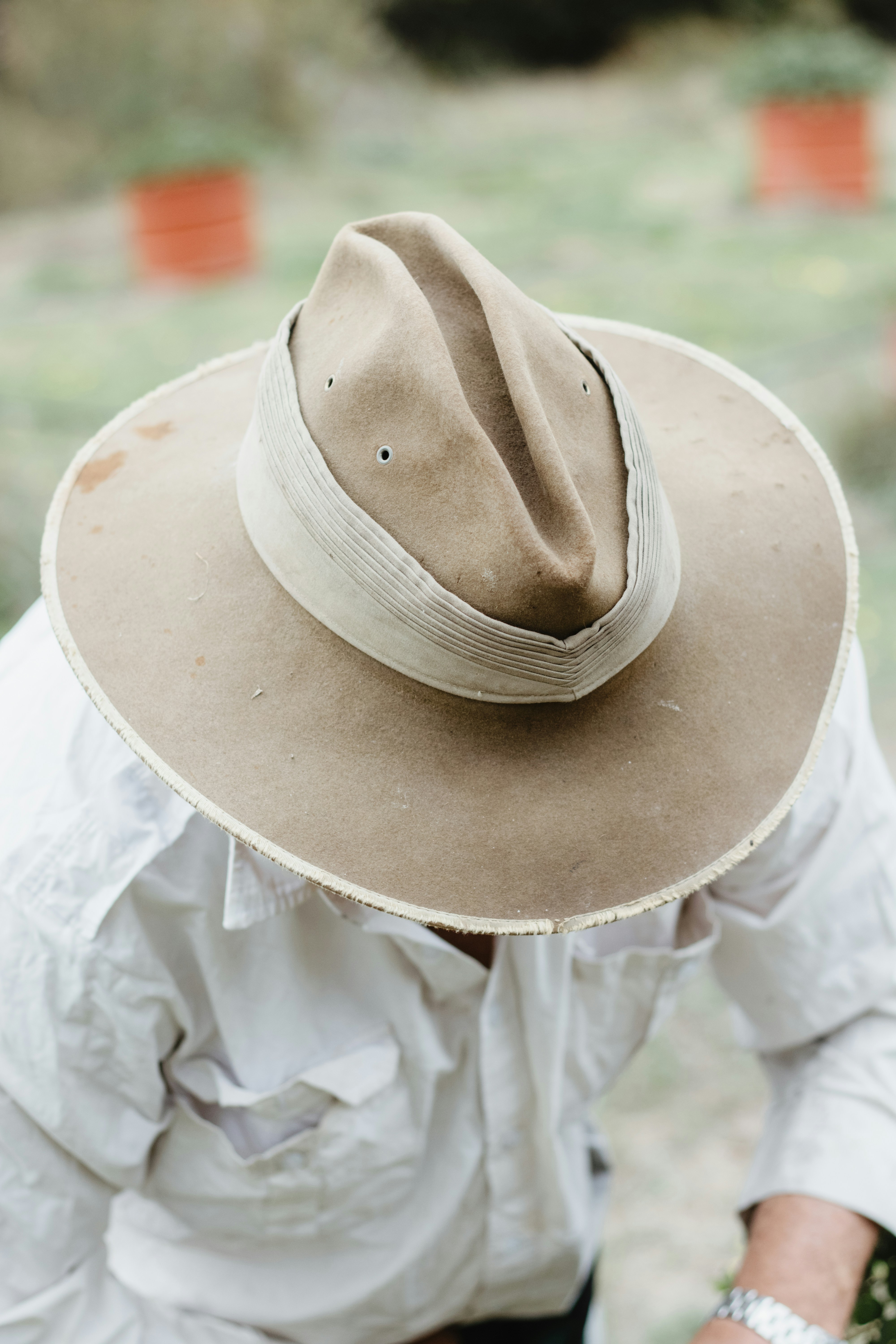 brown fedora hat on white textile
