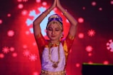 woman in red and gold sari dress