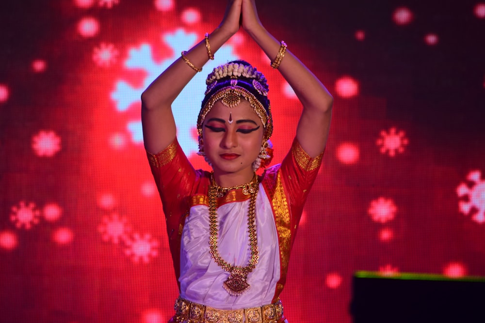 woman in red and gold sari dress