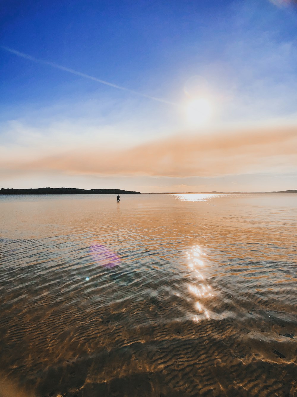 body of water under blue sky during daytime