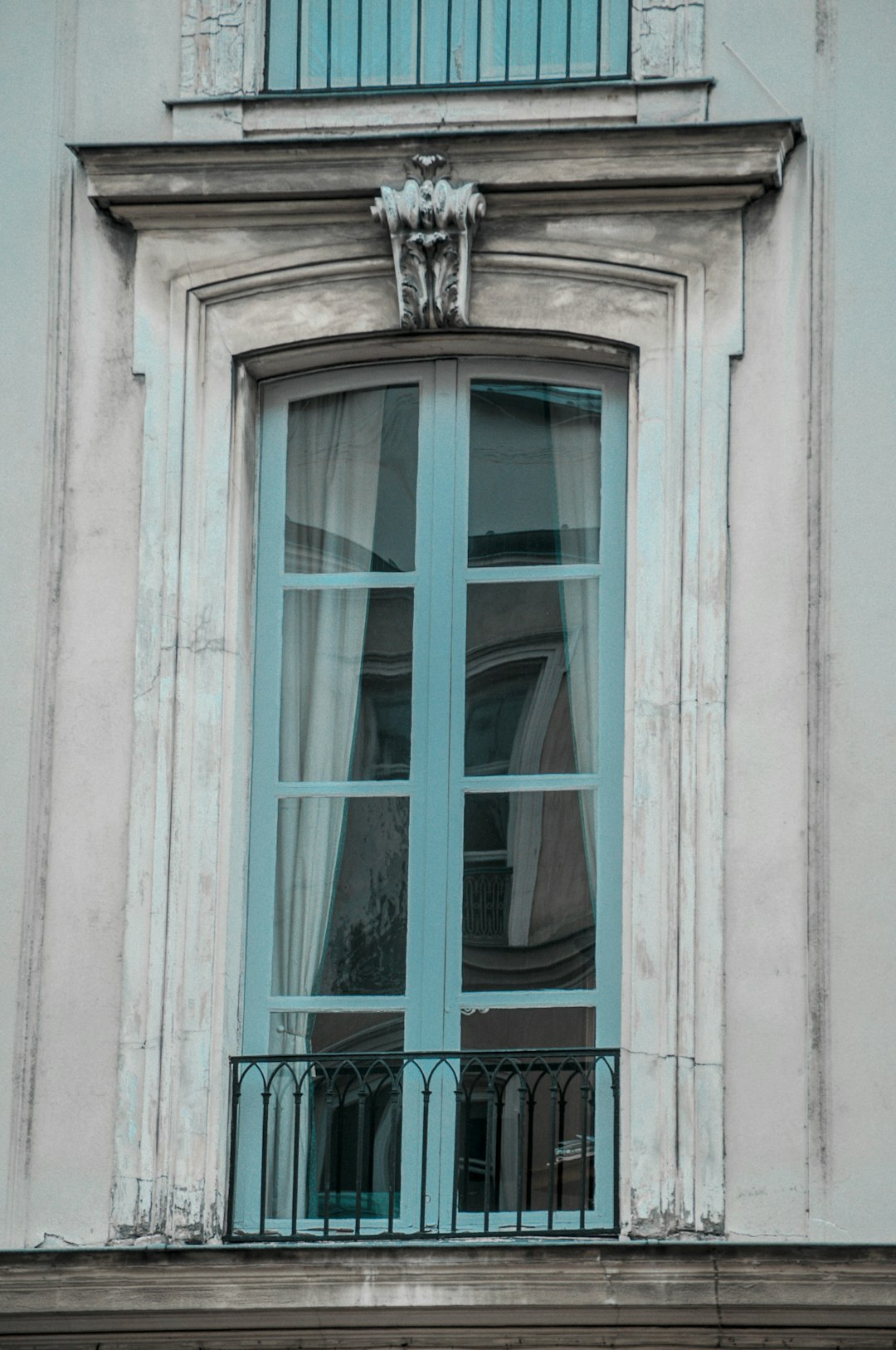 teal wooden window frame during daytime
