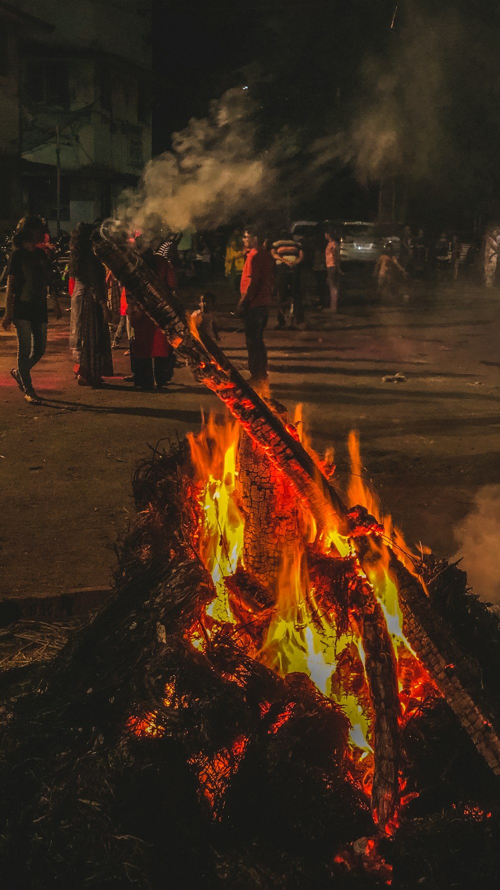 people standing near bonfire during nighttime