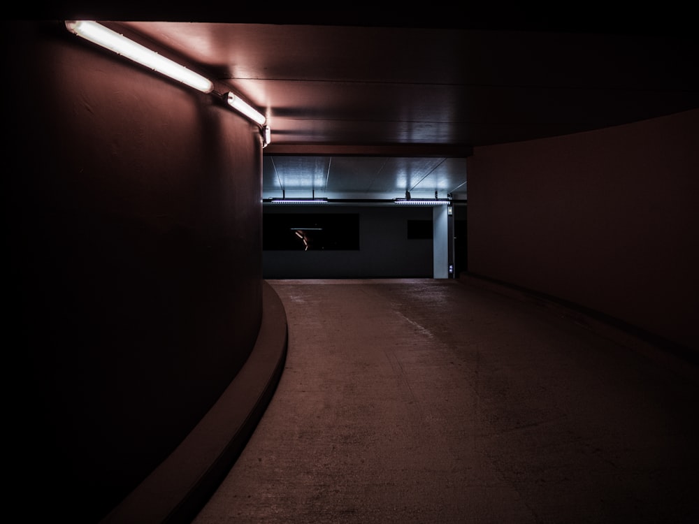 red and brown hallway with lights turned on in room