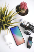 black and silver dslr camera beside iphone 6