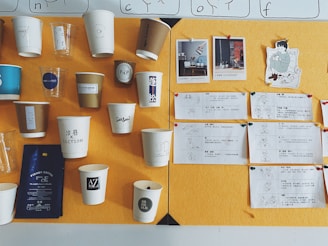 white paper cup on brown wooden table