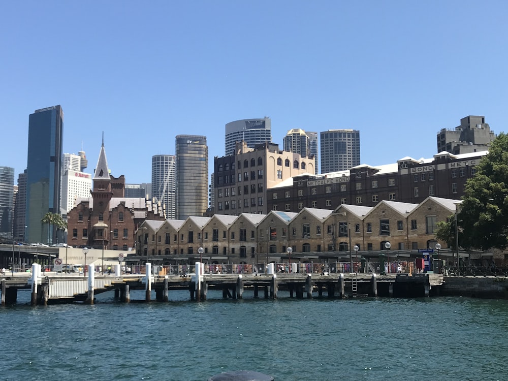 white and brown concrete building near body of water during daytime