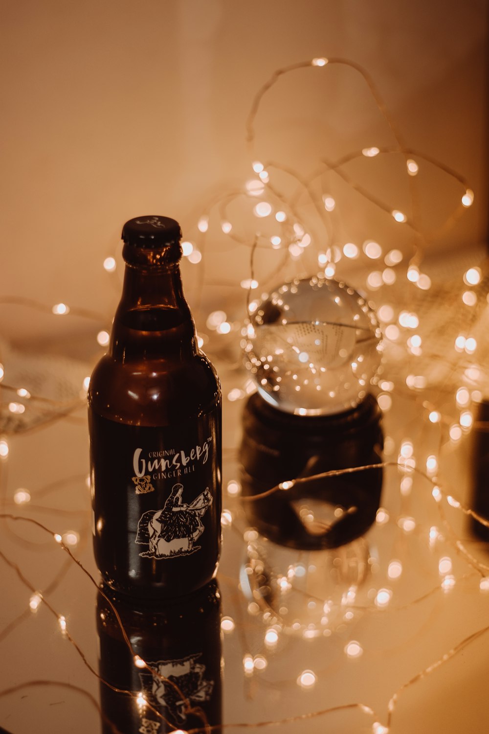 black and brown bottle on white table