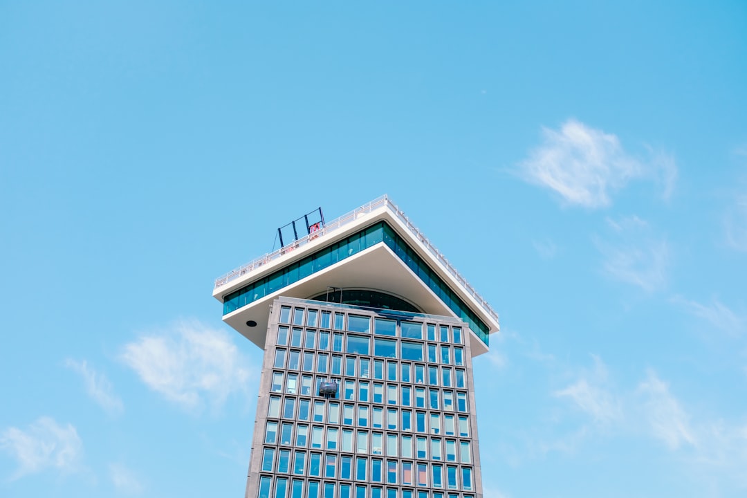 blue and white concrete building under blue sky during daytime