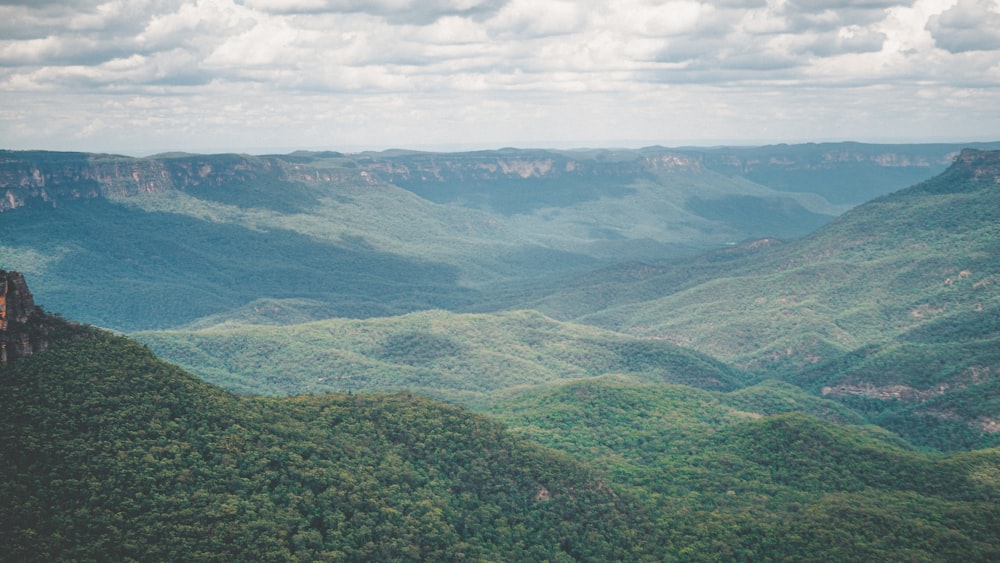 green mountains under white clouds during daytime