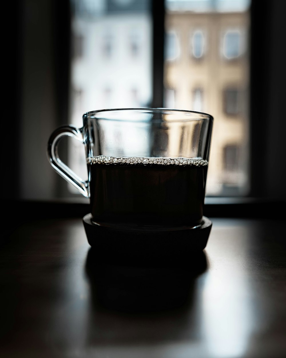 clear glass mug with brown liquid