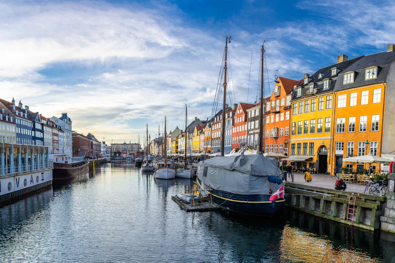 Colorful buildings and boats along a Copenhagen canal