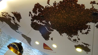 Map highlighting cafélume’s locations in Texas, Trieste, Trabzon, and Morocco with coffee beans and packaging visuals.