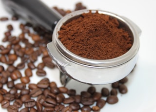 coffee beans on white ceramic mug