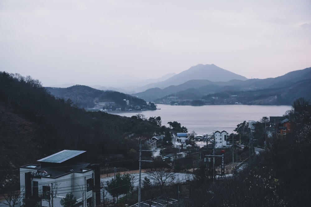 white and black house near body of water during daytime