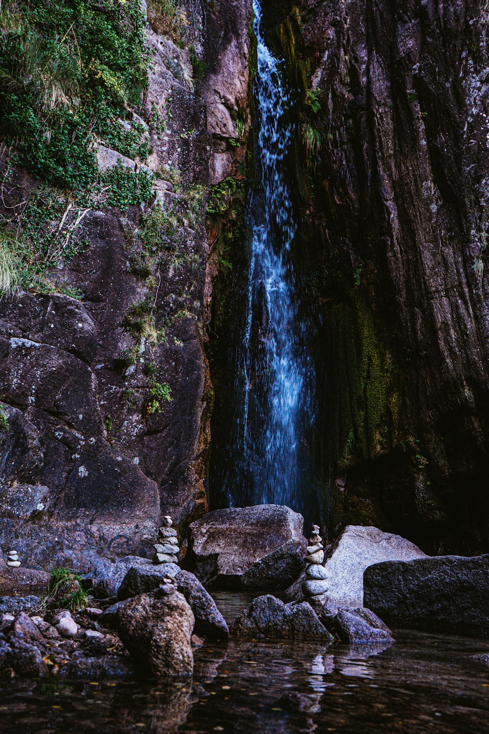 water falls in the middle of rocky mountain