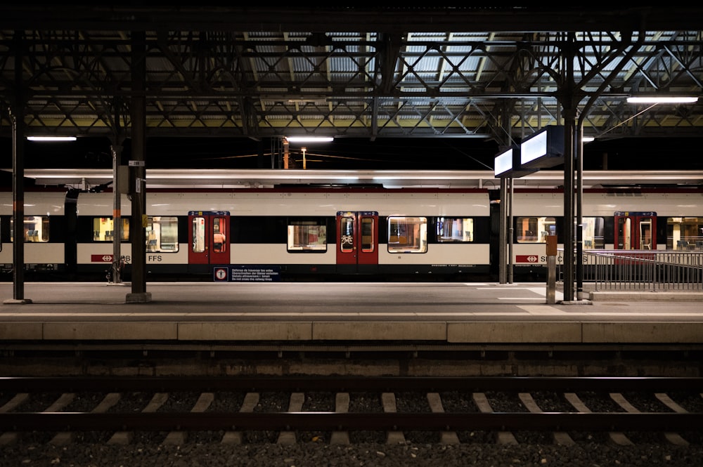 red and white train in train station