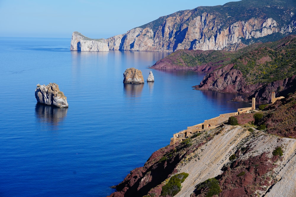 brown rock formation near body of water during daytime