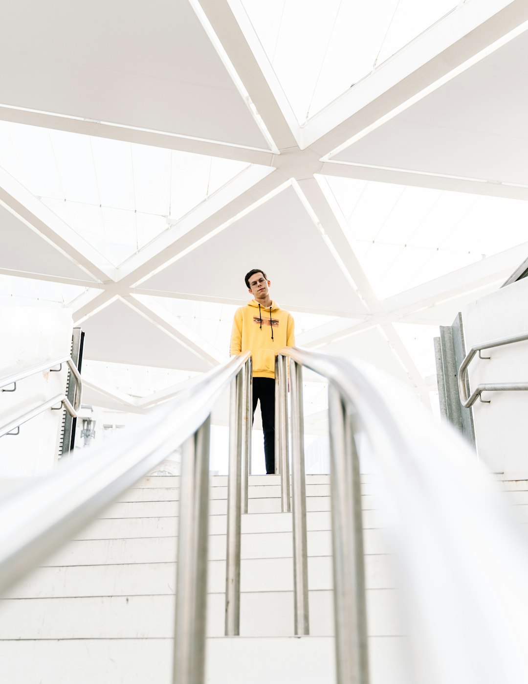 woman in yellow dress standing on white hallway