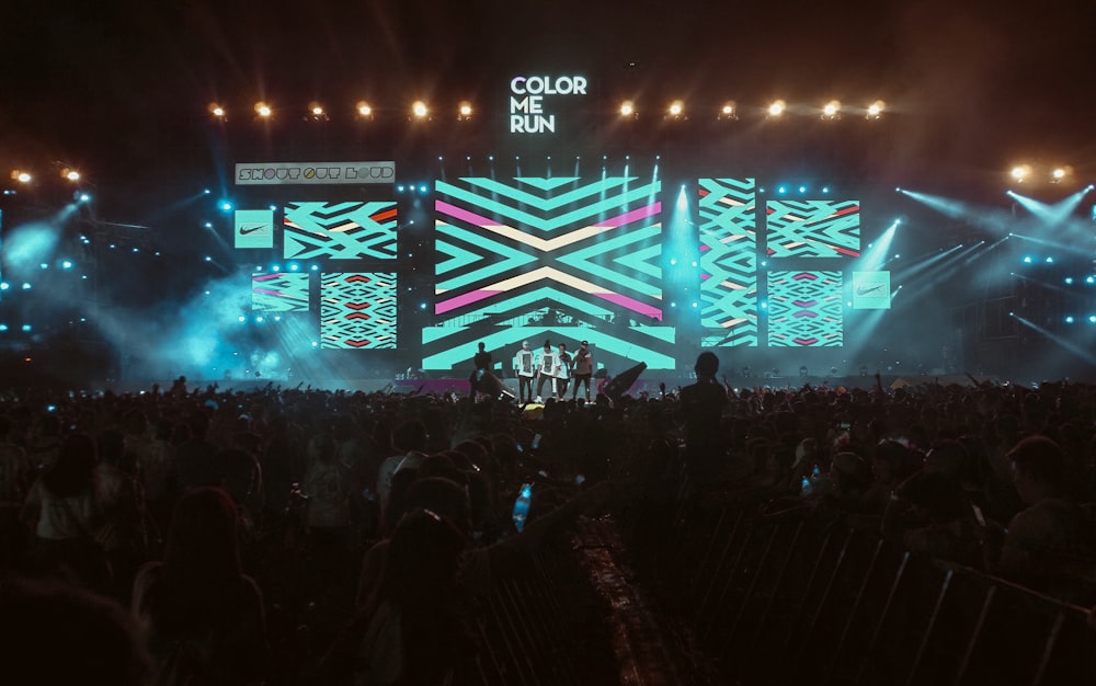 crowd of people watching concert during night time