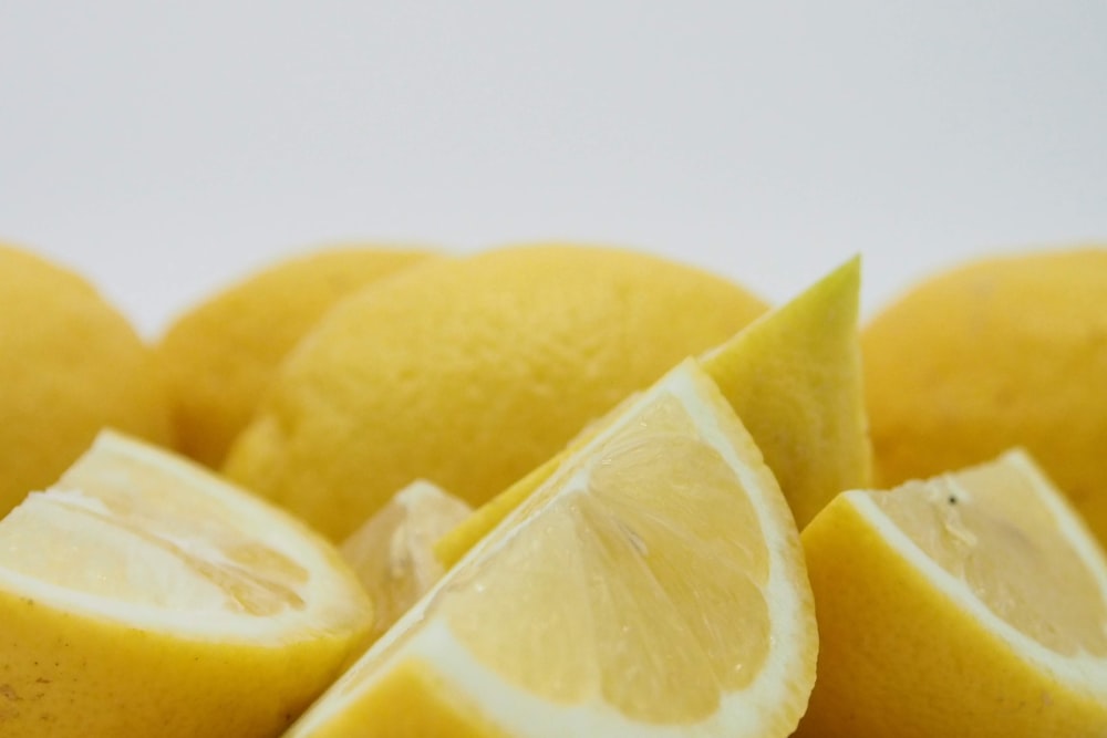 yellow lemon fruit on white surface