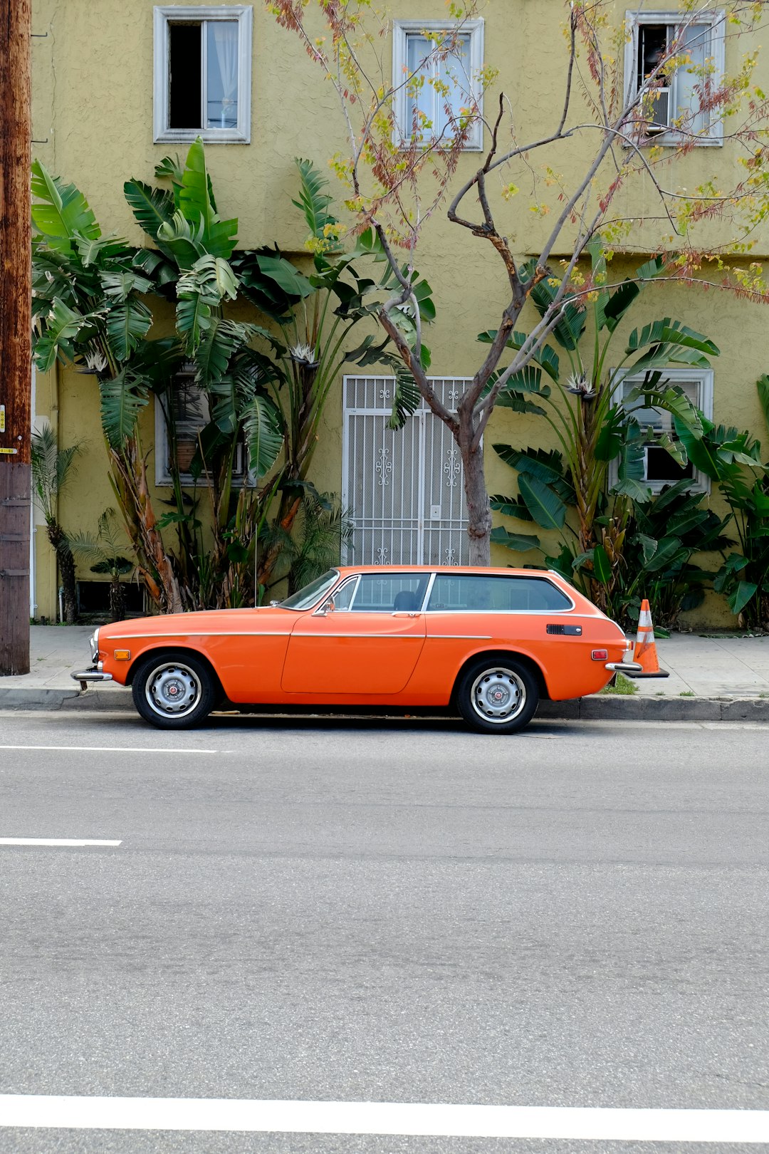 orange and black coupe on road during daytime