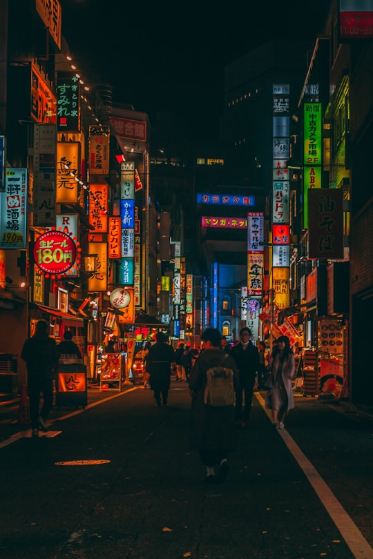 people walking on street during night time in Shinjuku Japan