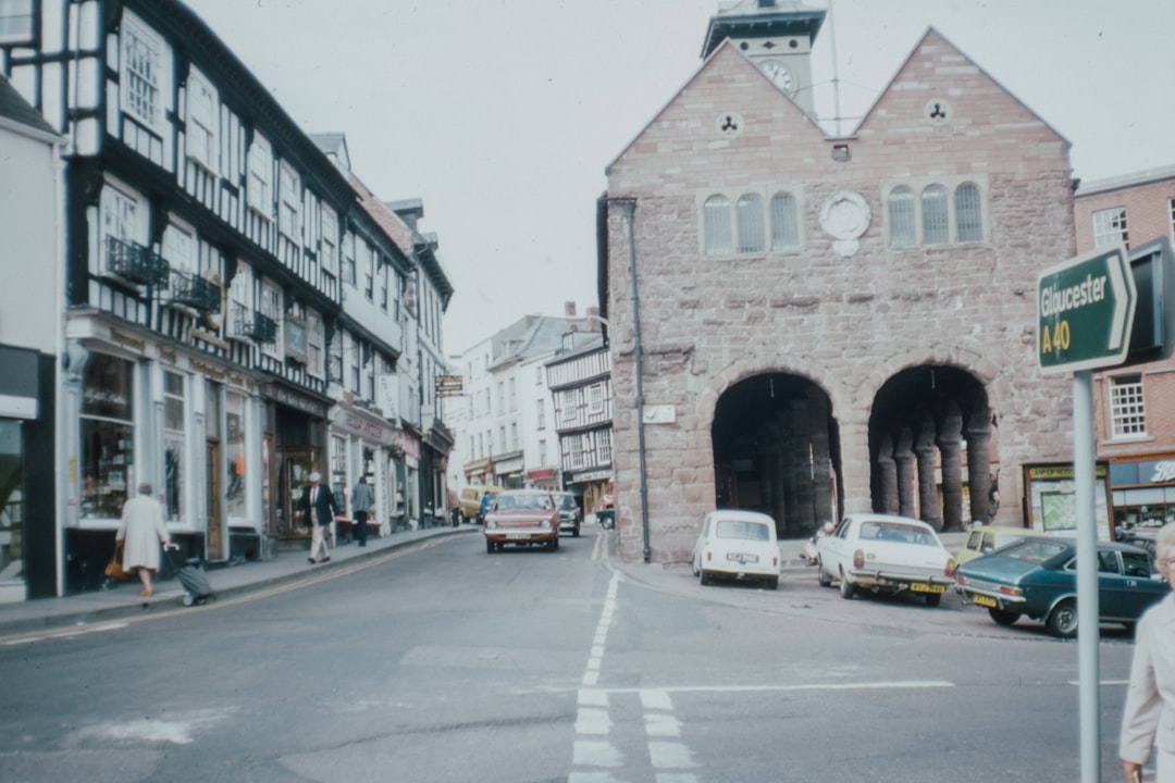 cars parked beside brown concrete building during daytime