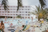 A family having fun at a poolside in a luxurious resort.