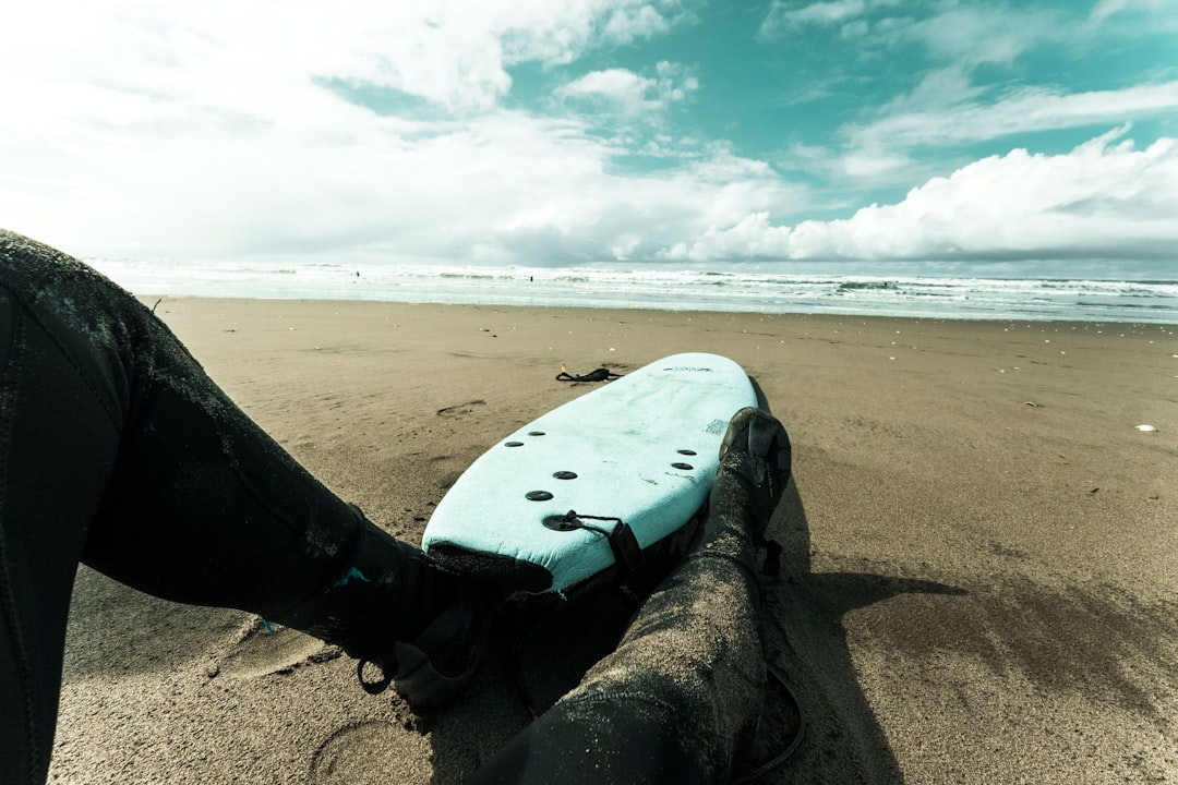 white and black skateboard on brown sand near sea during daytime