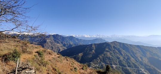 green and brown mountains under blue sky during daytime in Haibung Nepal