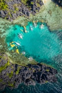aerial view of white and brown boat on sea during daytime