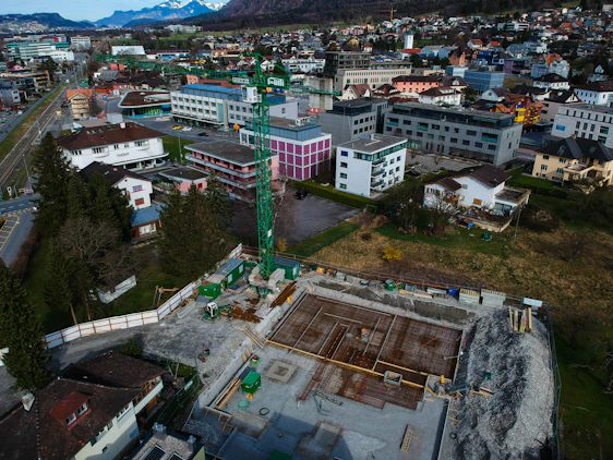 A panoramic view of a large-scale construction site in Aleppo showcasing cranes and engineers collaborating on a modern infrastructure project.