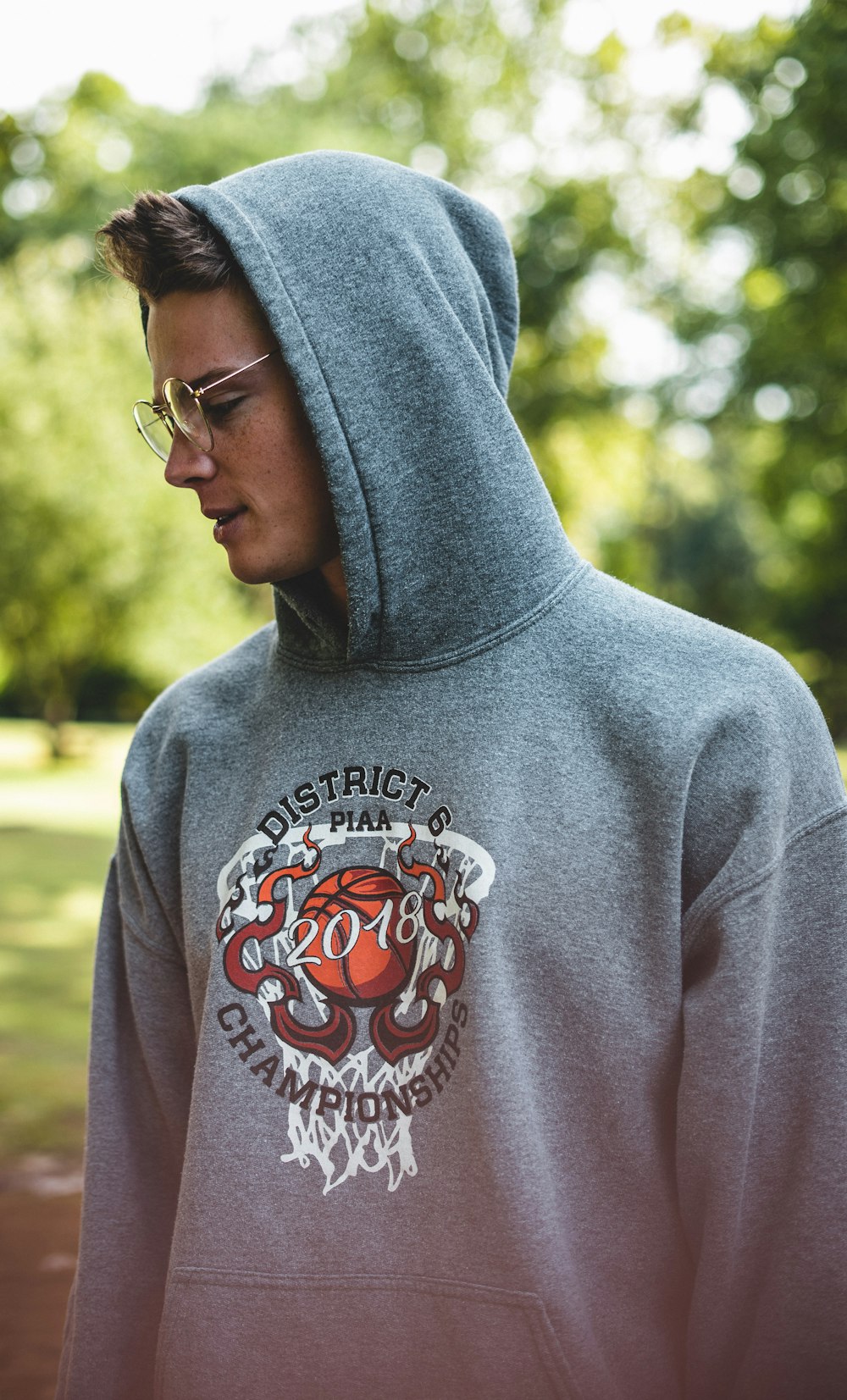 man in gray and red pullover hoodie wearing black framed eyeglasses